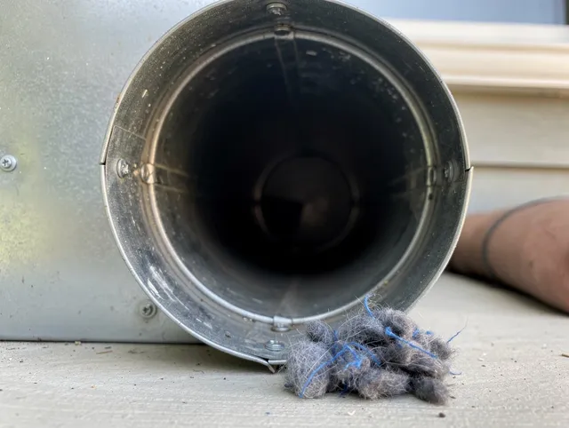 Palm Beach Gardens Dryer Vent Cleaning technician using specialized equipment to clear severe dryer vent blockage in Palm Beach Gardens